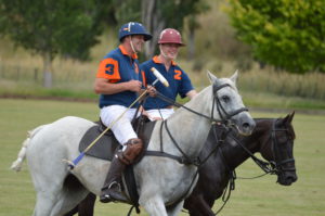 Polo player holding polo mallets